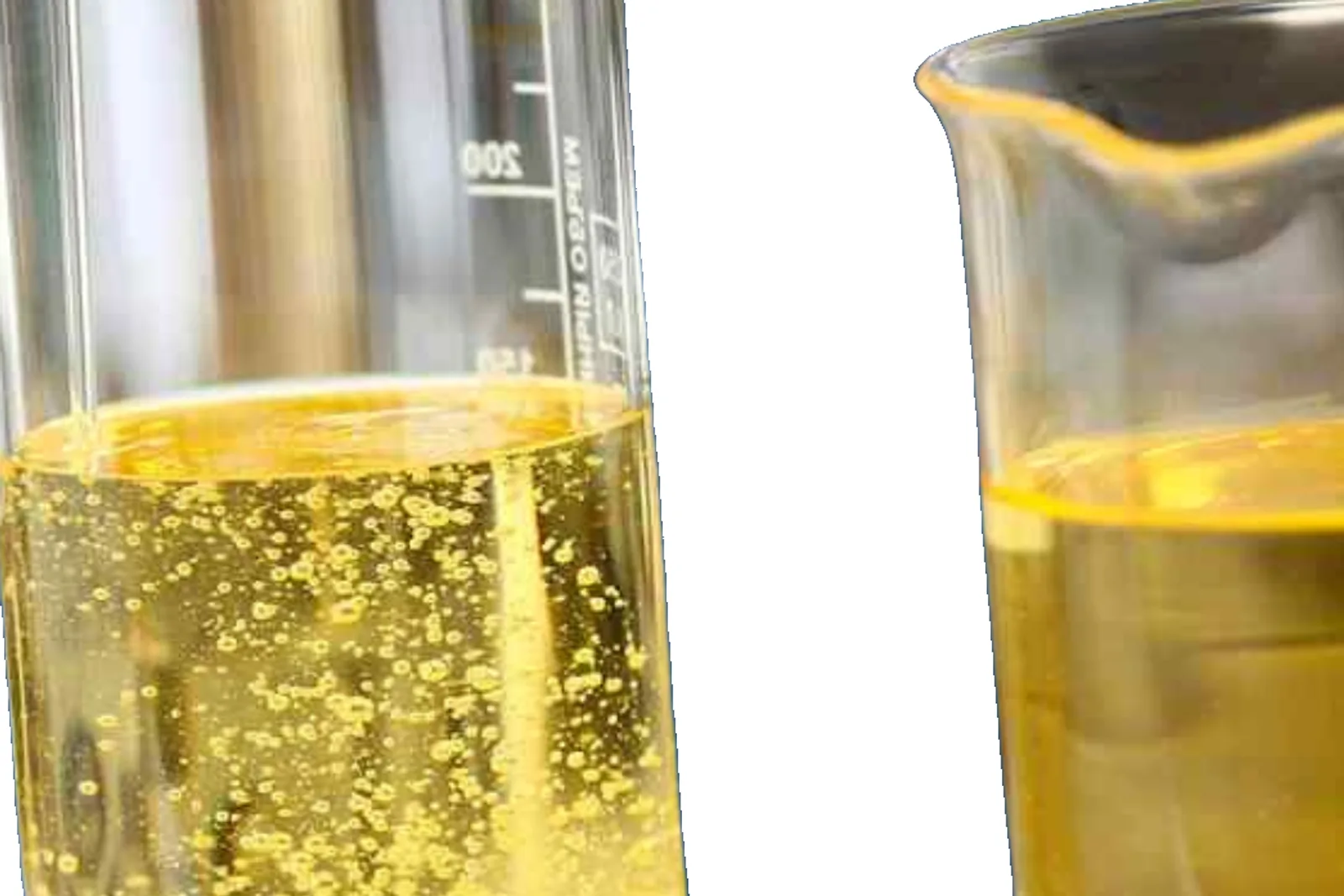 SN 500 base oil in clear graduated laboratory glassware showing golden viscous liquid texture.